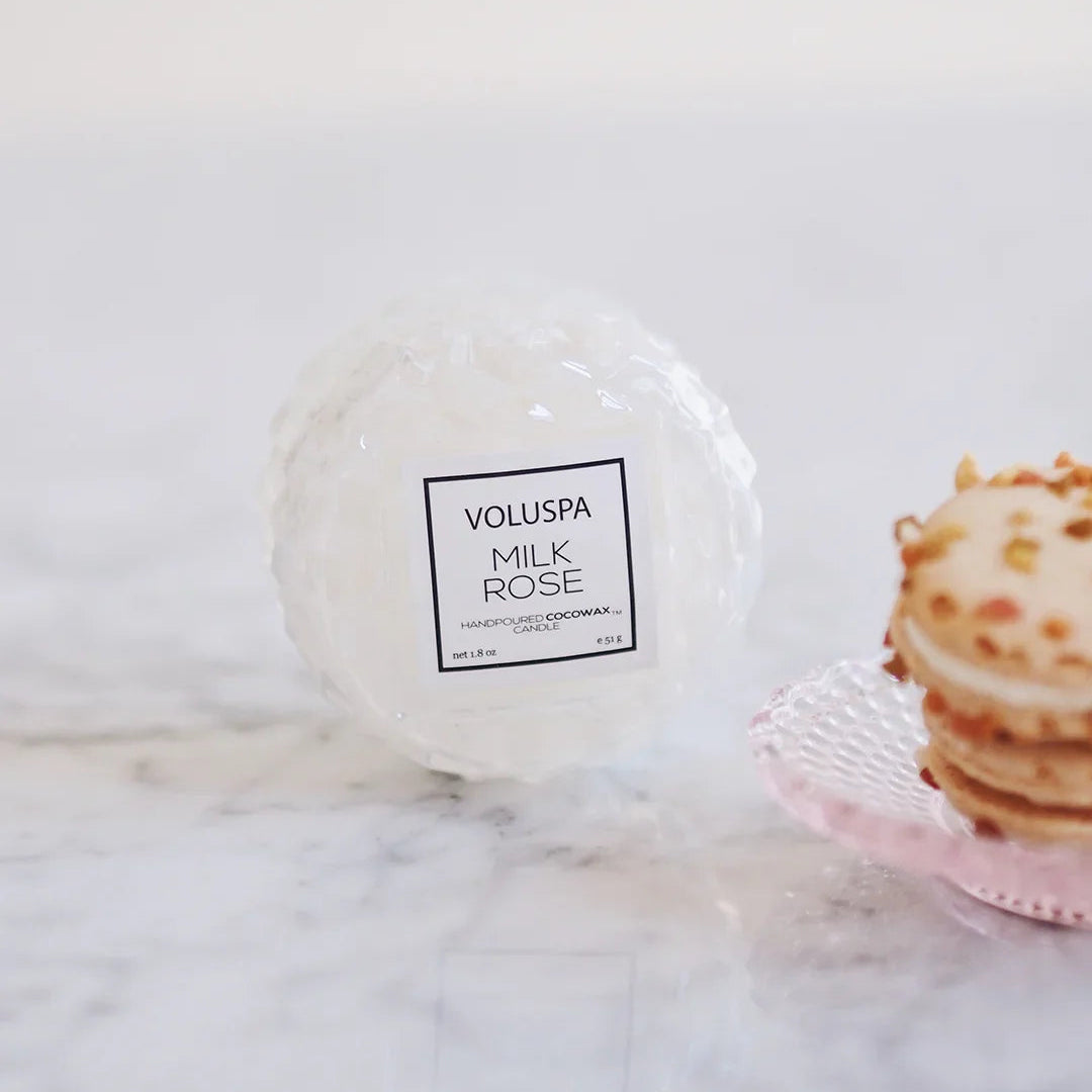 Voluspa Milk Rose candle on a marble surface